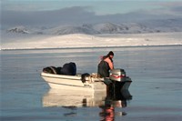 Hunter in his boat at the iceedge , image by Nanu Travel